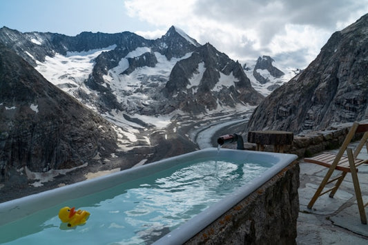 Ice bath with rubber duck - positioned on mountain range